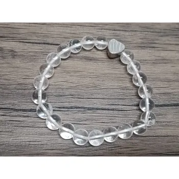 Náramek Náramek Křišťál EXTRA 8mm srdce (Korálkové náramky z minerálů - Křišťál EXTRA 8mm srdce CCE 54, s korálkem z nerezové oceli 304. Náramek je navlečen na elastické gumičce.)