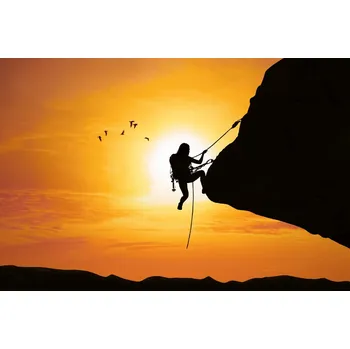 Fototapeta DIMEX | Vliesová fototapeta Horolezkyně při západu slunce MS-5-1577 | 375 x 250 cm| černá, žlutá, oranžová + Vliesová fototapeta na stěnu DIMEX Horolezkyně při západu slunce MS51577 v rozměru 375 x 250 cm + lepidlo zdarma