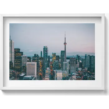 Obraz Obraz s bílým rámem a grafikou na zeď Panorama města večer 70x50 cm