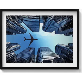 Obraz Dekorativní nástěnný obraz v rámu s grafikou Letadlo nad budovami 80x60 cm