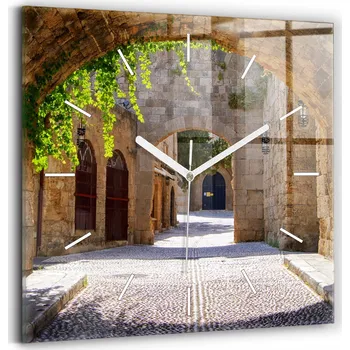 Hodiny Skleněné nástěnné hodiny do obýváku s grafikou Malebná ulice Rhodos 30x30 cm