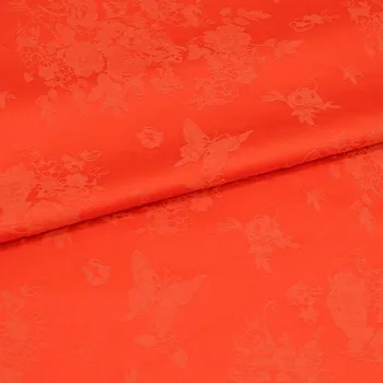 Kostýmovka 13999 oranžová, žakárové květy, š.145