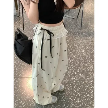 Dámské kalhoty letní kalhoty s volným střihem a puntíky s mašlí v pase Velikost: M, Barva (Varianta): Milky Apricot