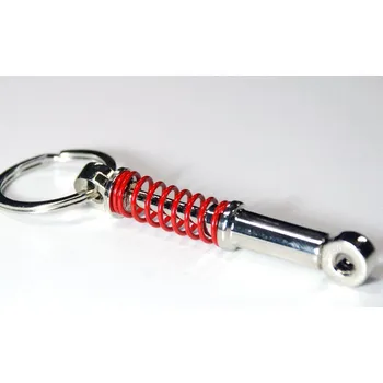 Přívěšek na klíče - tlumič s červenou pružinou