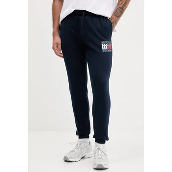 Bavlněné tepláky Tommy Jeans DM0DM22094 námořnická modř 59X, vel. M