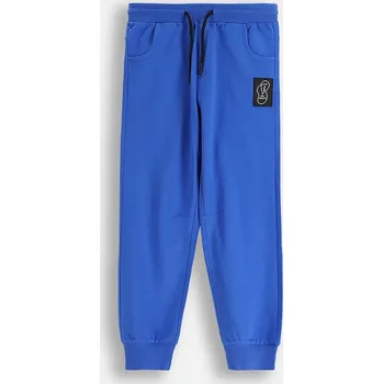 Chlapecké kalhoty Dětské bavlněné tepláky Coccodrillo ZC5120102VBA modrá 57X, vel. 146