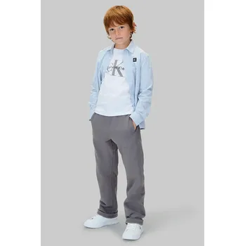 Chlapecké kalhoty Dětské bavlněné kalhoty Calvin Klein Jeans IB0IB02571.9BYA šedá 90X, vel. 164