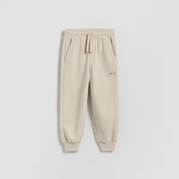 Dětská móda Reserved - Bavlněné jogger kalhoty - béžová - 474HK-08X - 474HK-08X-98