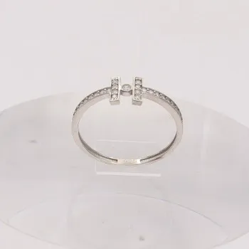 Prsten Zlatý prsten se zirkony z bílého zlata