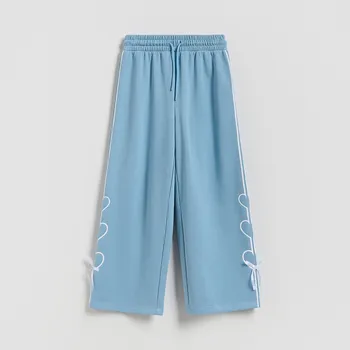 Dětská móda Reserved - Tepláky s&nbsp;ozdobnými mašlemi - světle tyrkysová - 117HN-60X - 117HN-60X-134