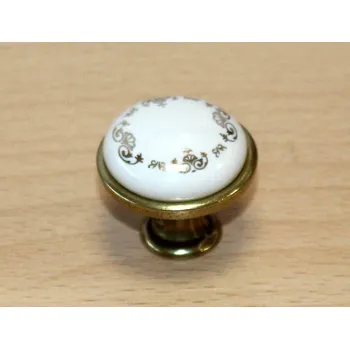 Nábytkové kování 11049 knopka 29mm mosaz - porcelánový ornament (Kulatá knopka kombinující lesklou mosaz a bílý porcelán s ornamentálním dekorem. Průměr 29mm, honosný a designový vzhled.)